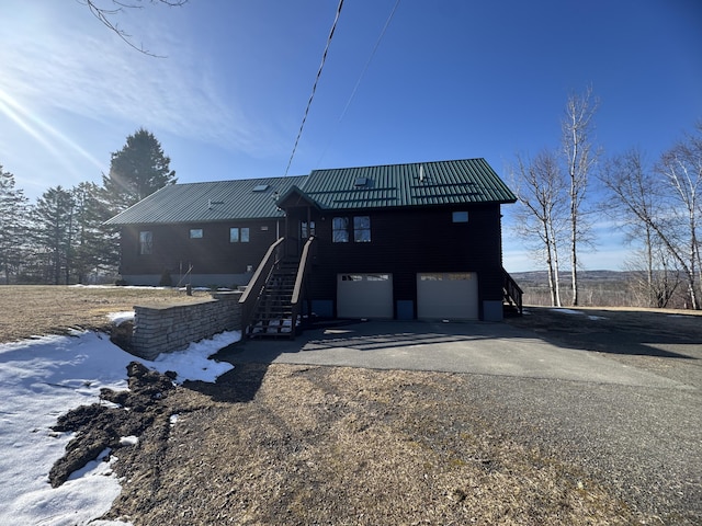 1083 N Rd, Ripley, ME 04930 - back of house featuring a garage, metal roof, and driveway