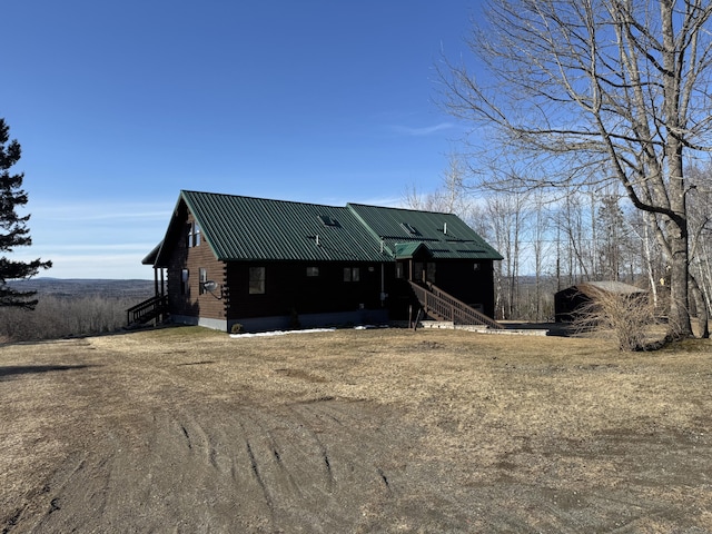 1083 N Rd, Ripley, ME 04930 - view of front of home with metal roof and log exterior