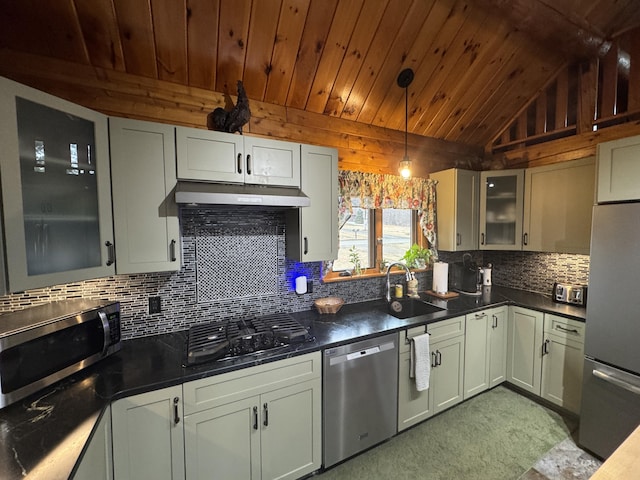 1083 N Rd, Ripley, ME 04930 - kitchen featuring tasteful backsplash, under cabinet range hood, dark countertops, a sink, and stainless steel appliances