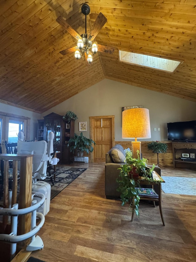 1083 N Rd, Ripley, ME 04930 - living room with vaulted ceiling with skylight, wood finished floors, ceiling fan, and wooden ceiling