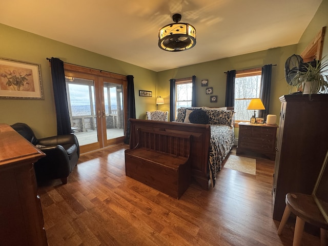 1083 N Rd, Ripley, ME 04930 - bedroom featuring dark wood-style flooring, french doors, access to outside, and multiple windows