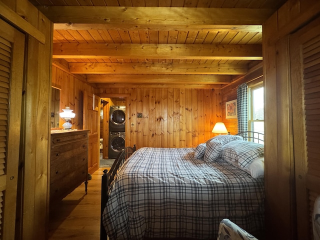 1083 N Rd, Ripley, ME 04930 - bedroom featuring wood ceiling, wood finished floors, wood walls, stacked washer and clothes dryer, and beam ceiling