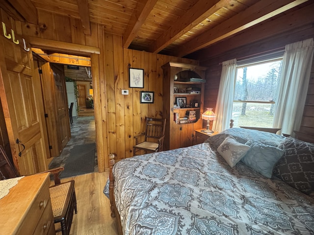 1083 N Rd, Ripley, ME 04930 - bedroom featuring wooden walls, beam ceiling, wooden ceiling, and wood finished floors