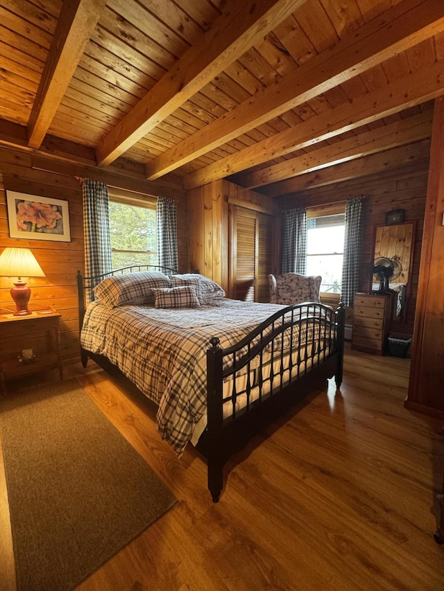 1083 N Rd, Ripley, ME 04930 - bedroom featuring wooden walls, multiple windows, and beam ceiling