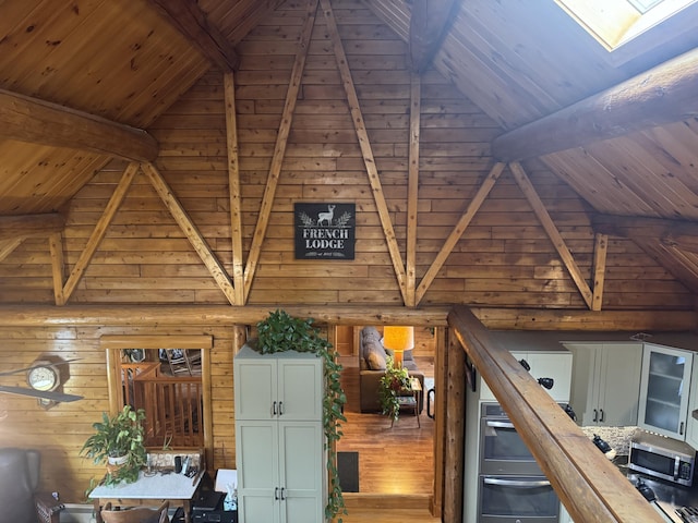1083 N Rd, Ripley, ME 04930 - interior space with beam ceiling, a skylight, high vaulted ceiling, wood ceiling, and wood finished floors