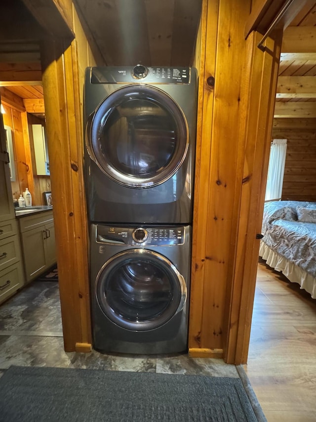 1083 N Rd, Ripley, ME 04930 - laundry room with wood walls, stacked washing maching and dryer, and laundry area