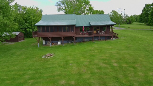 1083 N Rd, Ripley, ME 04930 - rear view of property with a lawn, a fire pit, and metal roof