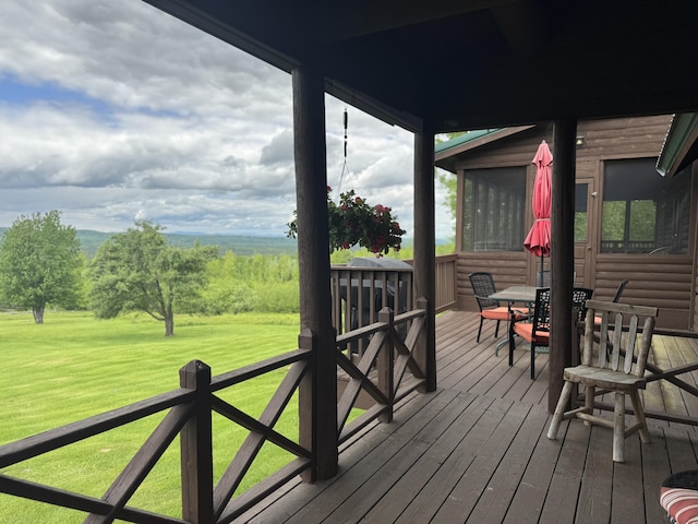1083 N Rd, Ripley, ME 04930 - wooden terrace featuring a sunroom, a lawn, and outdoor dining space