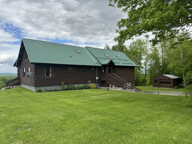 1083 N Rd, Ripley, ME 04930 - view of front of property featuring an outdoor structure, a front lawn, metal roof, and log siding