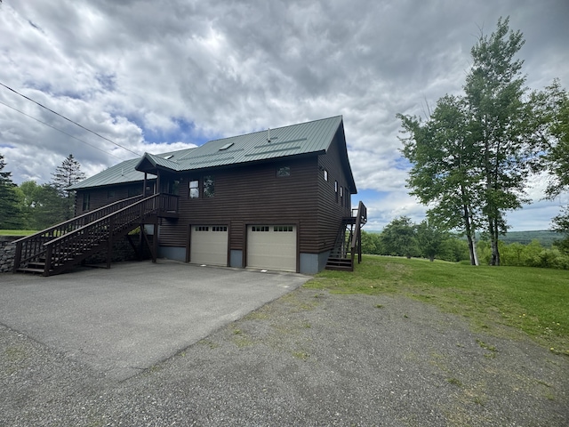 1083 N Rd, Ripley, ME 04930 - view of property exterior featuring stairs, driveway, a garage, a yard, and metal roof