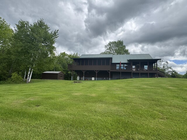 1083 N Rd, Ripley, ME 04930 - rear view of house featuring a lawn, a deck, and metal roof