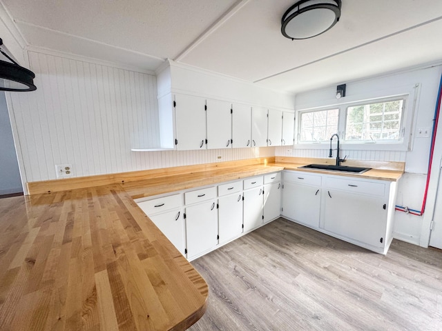108/9 113 Sandy Beach Rd, Glenburn, ME 04401 - kitchen with white cabinets, wood counters, light wood finished floors, and a sink