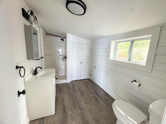 108/9 113 Sandy Beach Rd, Glenburn, ME 04401 - bathroom with wood finished floors, a shower stall, vaulted ceiling, toilet, and vanity