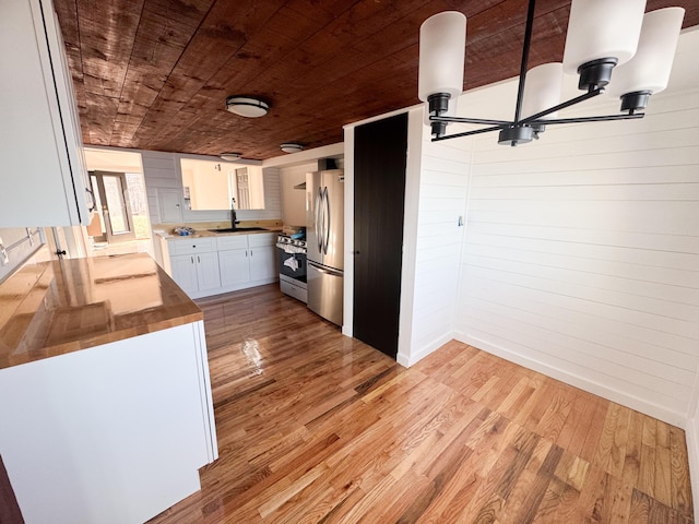 108/9 113 Sandy Beach Rd, Glenburn, ME 04401 - kitchen with wooden ceiling, wood counters, light wood-style flooring, white cabinets, and appliances with stainless steel finishes
