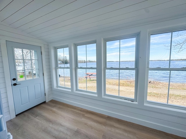 108/9 113 Sandy Beach Rd, Glenburn, ME 04401 - unfurnished sunroom featuring lofted ceiling, wood finished floors, and a water view