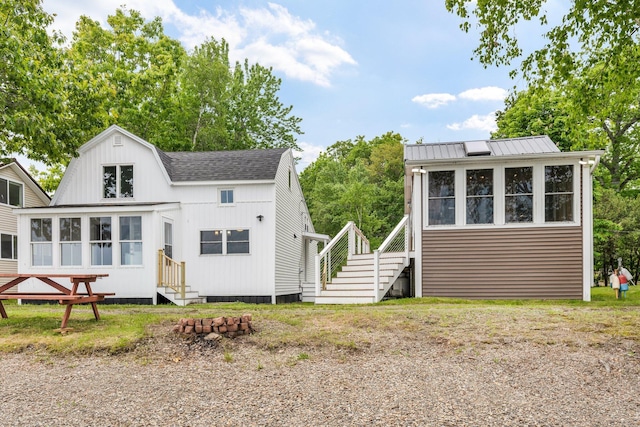 108/9 113 Sandy Beach Rd, Glenburn, ME 04401 - view of front of property featuring entry steps, a sunroom, and stairs