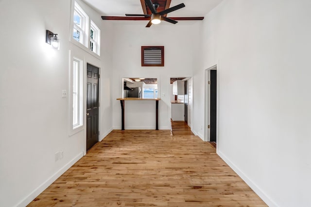 108/9 113 Sandy Beach Rd, Glenburn, ME 04401 - entrance foyer with a towering ceiling, light wood-type flooring, and ceiling fan