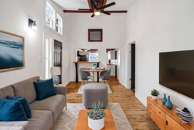 108/9 113 Sandy Beach Rd, Glenburn, ME 04401 - living area featuring a towering ceiling, a ceiling fan, and light wood finished floors