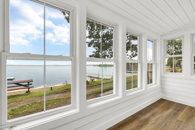108/9 113 Sandy Beach Rd, Glenburn, ME 04401 - unfurnished sunroom featuring a water view and wood finished floors