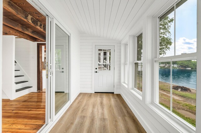 108/9 113 Sandy Beach Rd, Glenburn, ME 04401 - unfurnished sunroom with healthy amount of natural light and a water view