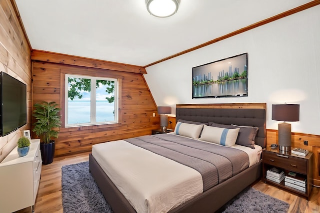 108/9 113 Sandy Beach Rd, Glenburn, ME 04401 - bedroom featuring wood walls, light wood finished floors, and crown molding