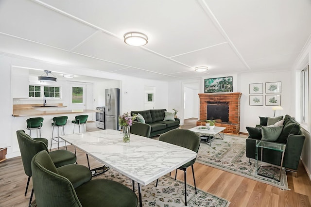 108/9 113 Sandy Beach Rd, Glenburn, ME 04401 - dining space featuring light wood-style flooring and a fireplace