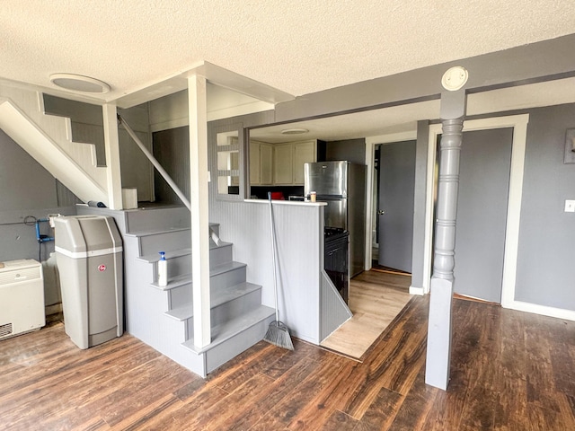 108/9 113 Sandy Beach Rd, Glenburn, ME 04401 - basement featuring a textured ceiling, stairs, and wood finished floors