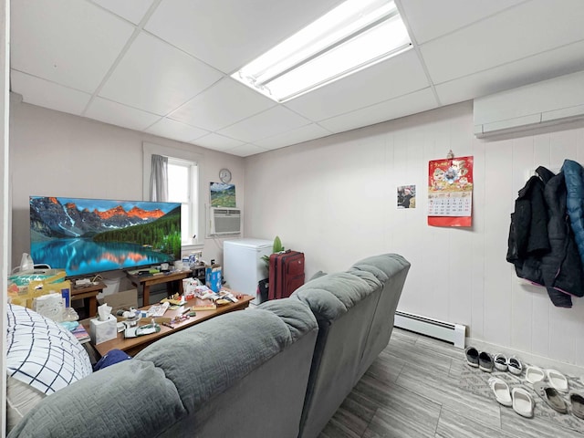 1716 Main St, Mapleton, ME 04757 - living area with a paneled ceiling, a baseboard heating unit, and cooling unit