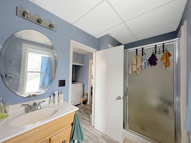 1716 Main St, Mapleton, ME 04757 - full bathroom featuring washer / clothes dryer, a stall shower, wood finished floors, and vanity