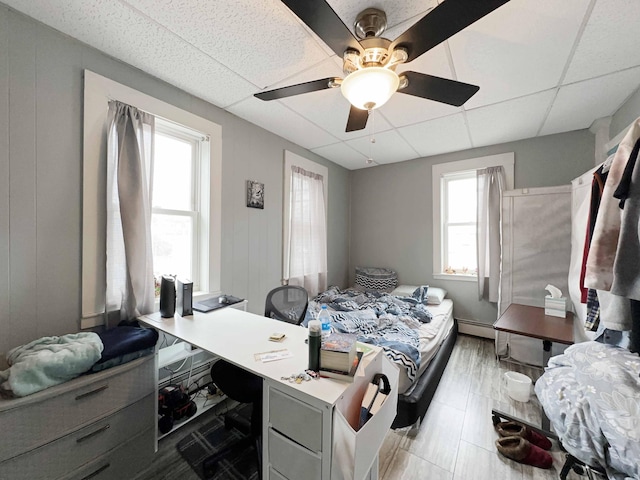 1716 Main St, Mapleton, ME 04757 - bedroom with a paneled ceiling, a baseboard radiator, and a ceiling fan