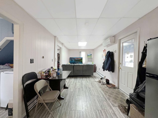 1716 Main St, Mapleton, ME 04757 - interior space featuring a wall mounted air conditioner, washer / clothes dryer, and a paneled ceiling