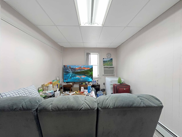 1716 Main St, Mapleton, ME 04757 - living area with baseboard heating, a paneled ceiling, and cooling unit