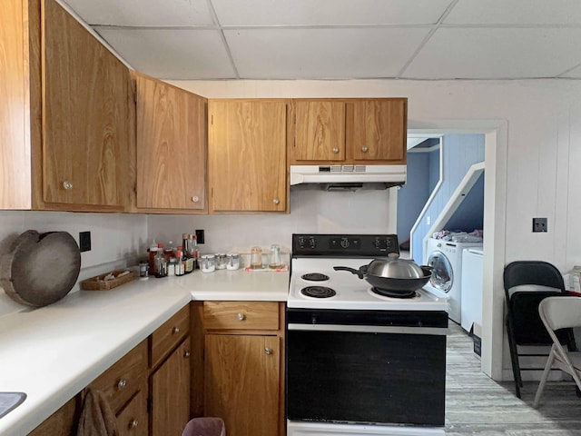 1716 Main St, Mapleton, ME 04757 - kitchen with a paneled ceiling, light countertops, under cabinet range hood, washer and clothes dryer, and electric stove