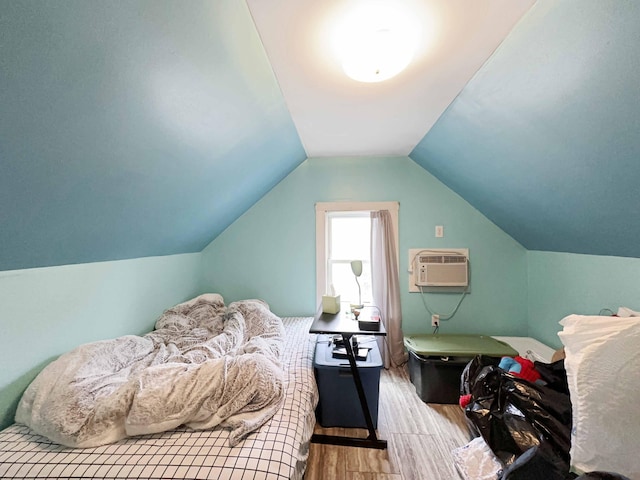 1716 Main St, Mapleton, ME 04757 - bedroom with a wall mounted AC, wood finished floors, and lofted ceiling
