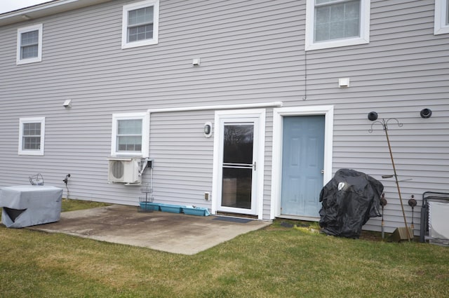 rear view of property featuring a patio, cooling unit, and a lawn
