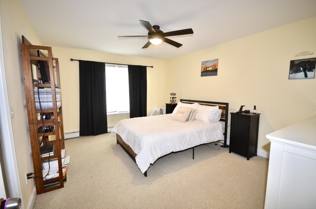 bedroom featuring baseboard heating, light colored carpet, and baseboards