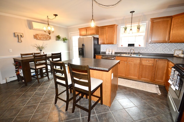kitchen featuring stainless steel appliances, baseboard heating, a sink, and dark countertops