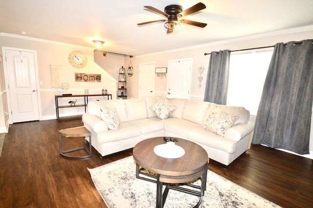 living room featuring ornamental molding, ceiling fan, baseboards, and dark wood finished floors
