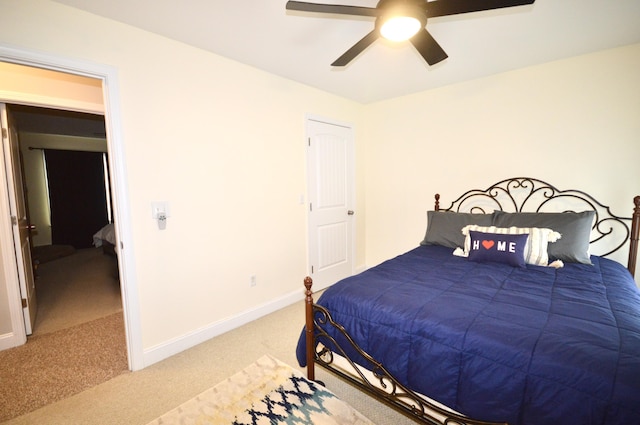 bedroom featuring baseboards, a ceiling fan, and carpet