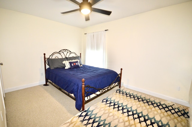 carpeted bedroom featuring baseboards and a ceiling fan
