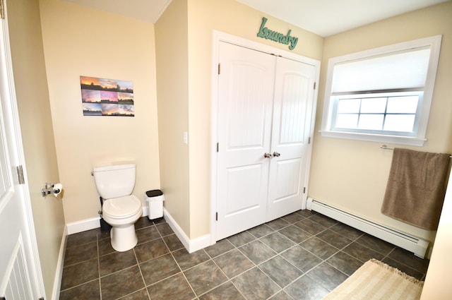 bathroom featuring toilet, a baseboard radiator, baseboards, and tile patterned floors