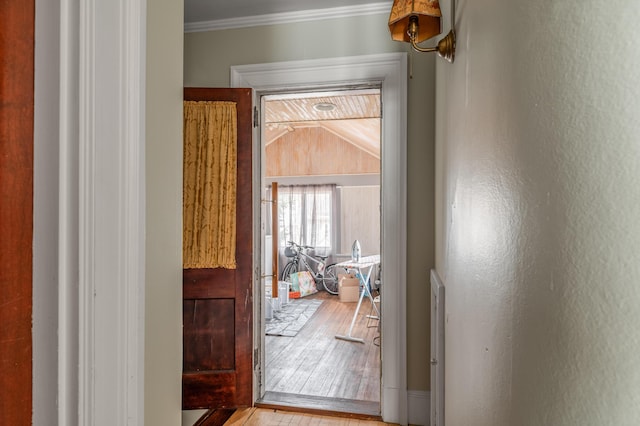 interior space with ornamental molding and wood finished floors