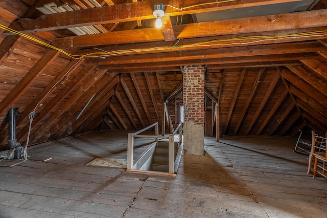 unfinished attic with an upstairs landing