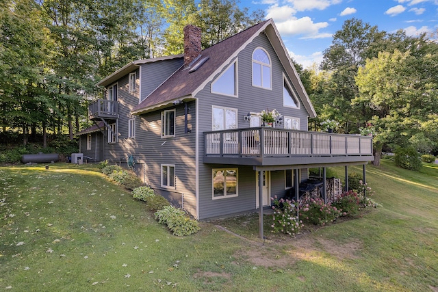 252 General Turner Hill Rd, Turner, ME 04282 - back of house featuring central AC unit, a deck, a lawn, and a chimney