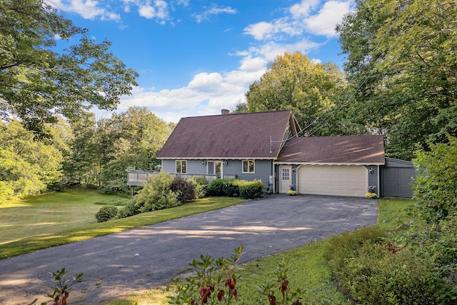 252 General Turner Hill Rd, Turner, ME 04282 - cape cod house with a chimney, driveway, an attached garage, a front lawn, and a shingled roof