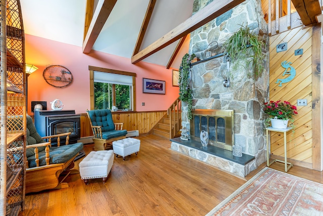 252 General Turner Hill Rd, Turner, ME 04282 - living room featuring beam ceiling, wood walls, wood finished floors, and stairs