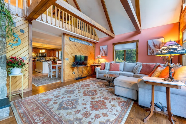 252 General Turner Hill Rd, Turner, ME 04282 - living room featuring beamed ceiling, high vaulted ceiling, wood-type flooring, and wooden walls