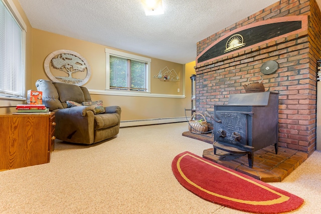 252 General Turner Hill Rd, Turner, ME 04282 - carpeted living room featuring a wood stove, a textured ceiling, and baseboard heating