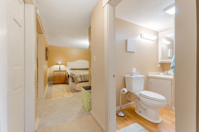252 General Turner Hill Rd, Turner, ME 04282 - bathroom featuring vanity, a textured ceiling, baseboards, and toilet