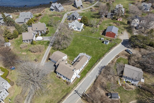 birds eye view of property with a residential view and a water view